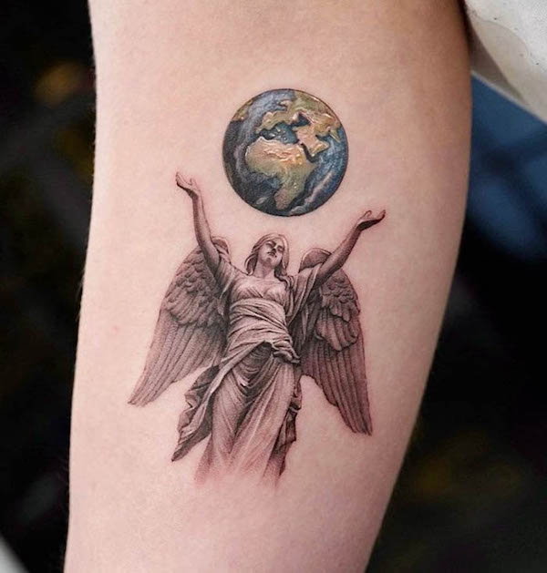 Angel and the globe tattoo by @drag_ink