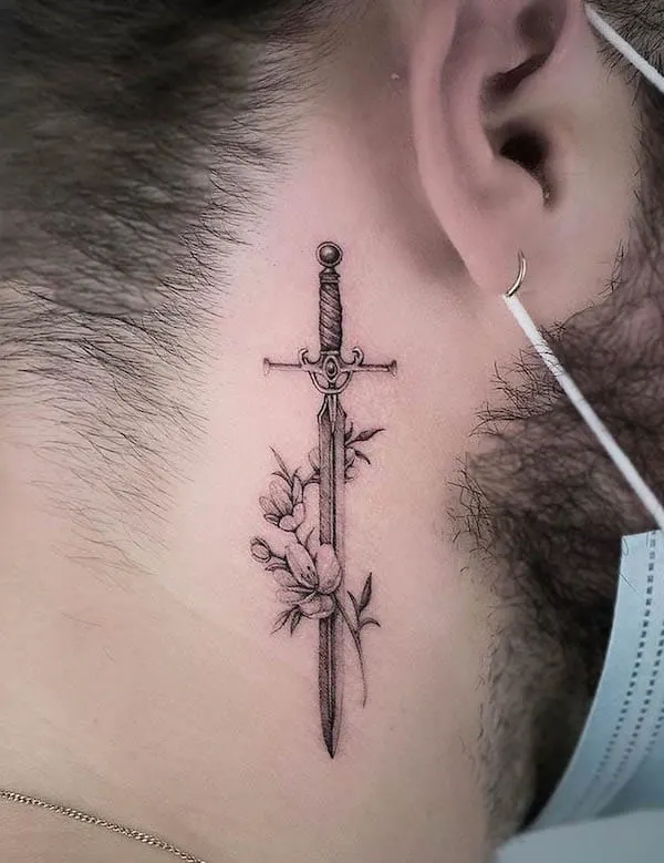 Behind-the-ear sword tattoo by @txttooing