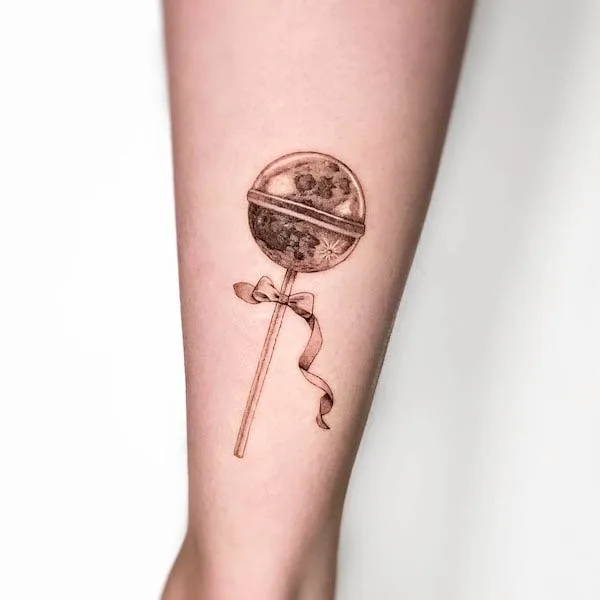 Black and grey lollipop cute tattoo by @mogiz.tattoo