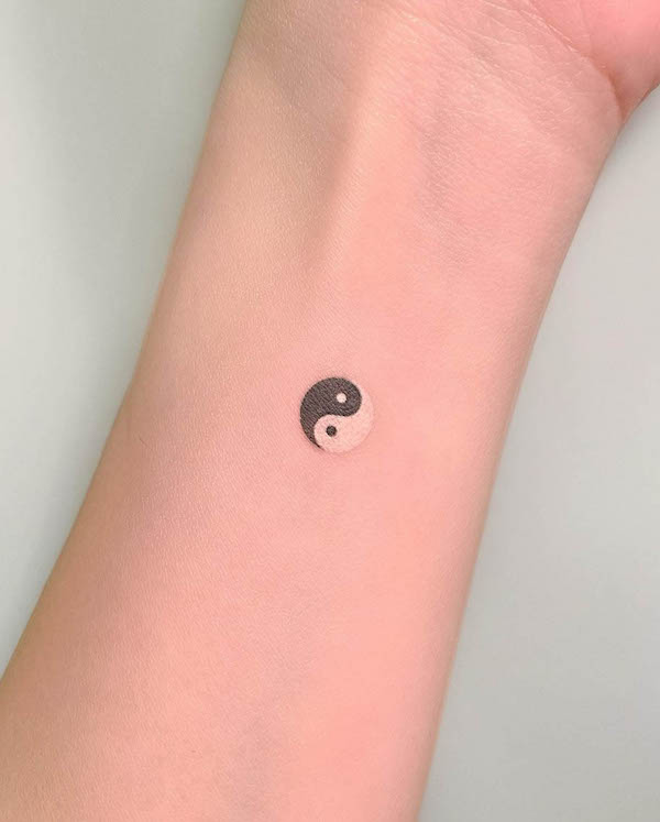 Black and white yin yang wrist tattoo by @nientattoo