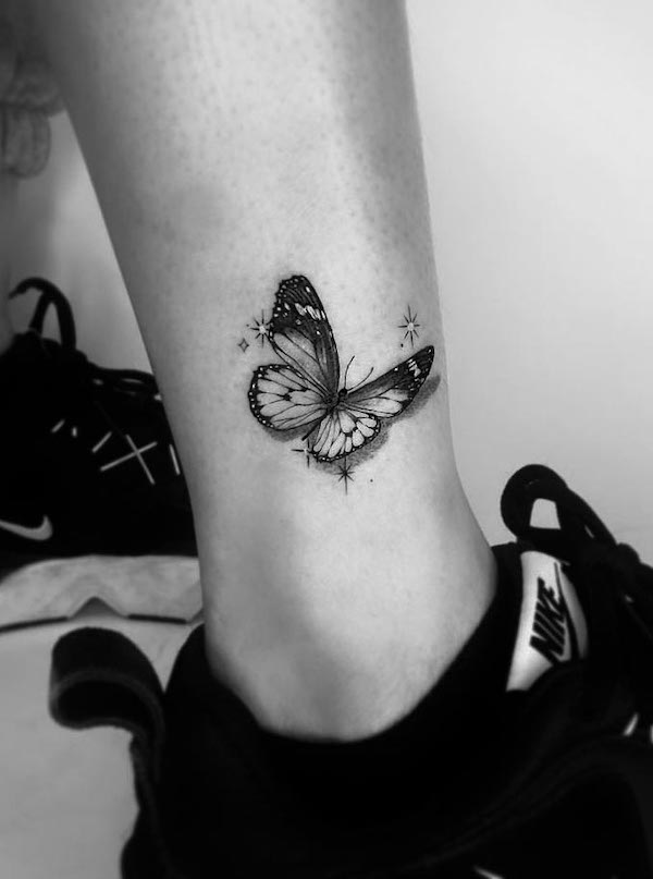 Black butterfly ankle tattoo by @yuantattoodesign