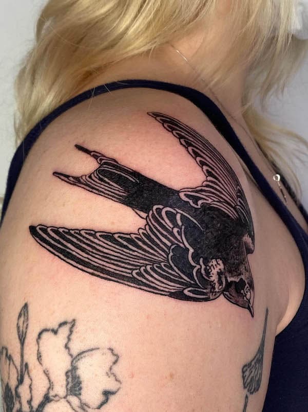 Black traditional swallow tattoo by @fl0atingb0nes