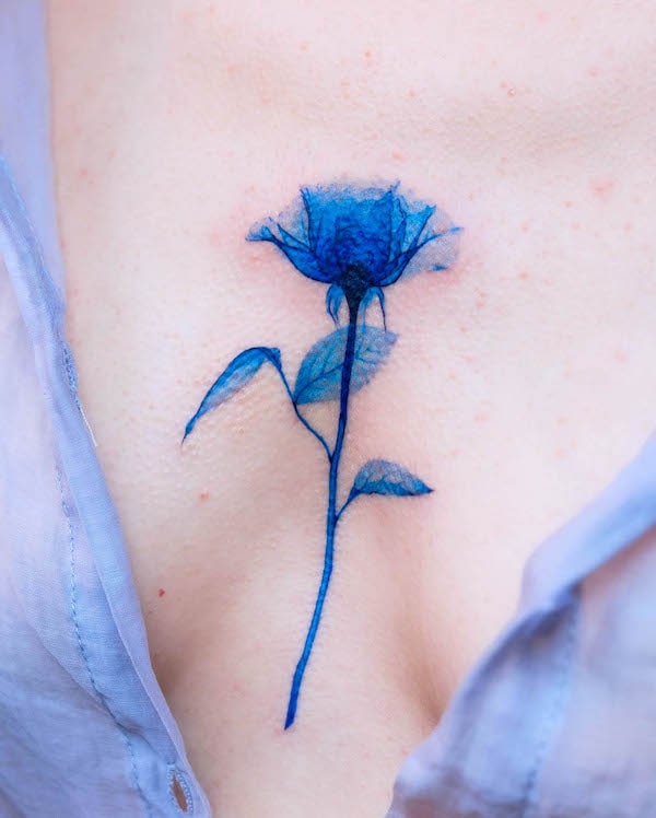 Blue rose between the boobs tattoo by @pokhy_tattoo