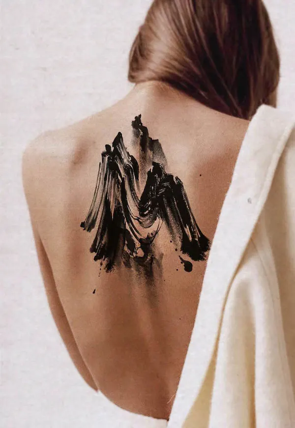 Bold and beautiful abstract mountain back tattoo by @tattooist_soma