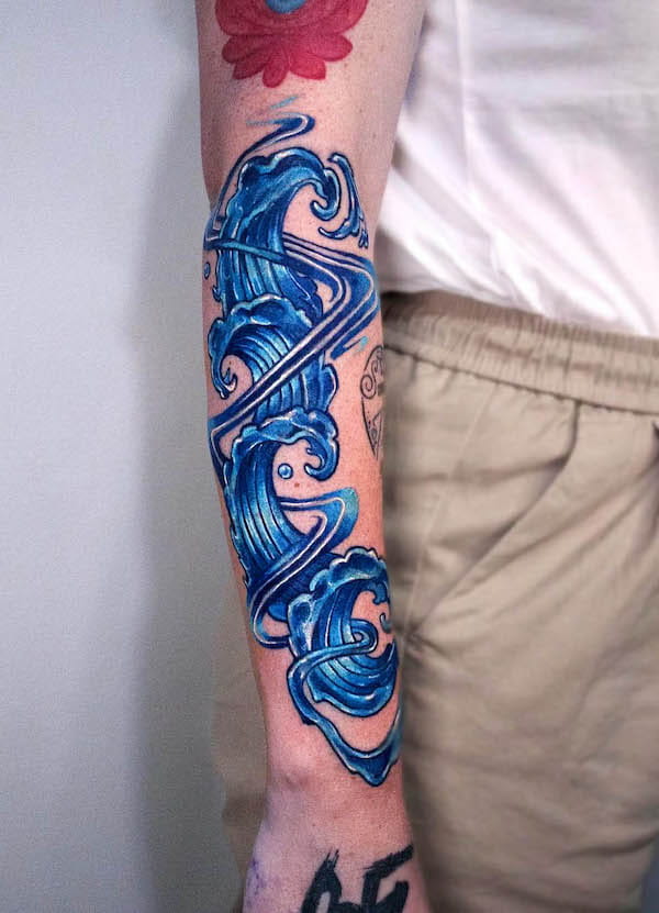 Bold blue forearm tattoo by @melange.tattoo