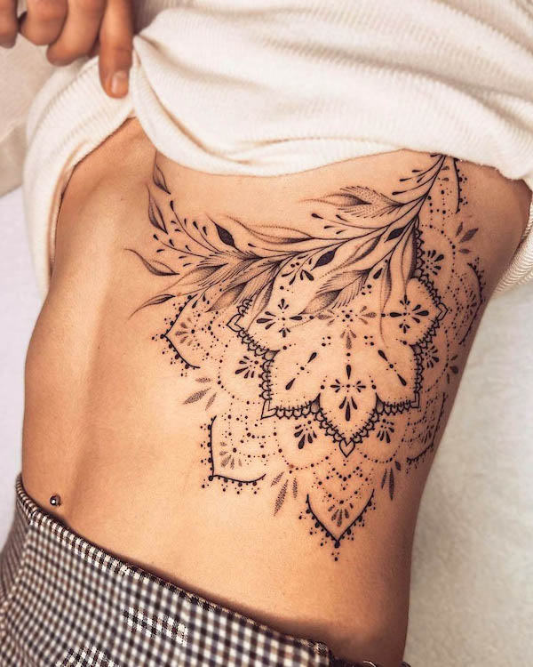 Bold mandala rib tattoo by @fanny.loart_.tattoo