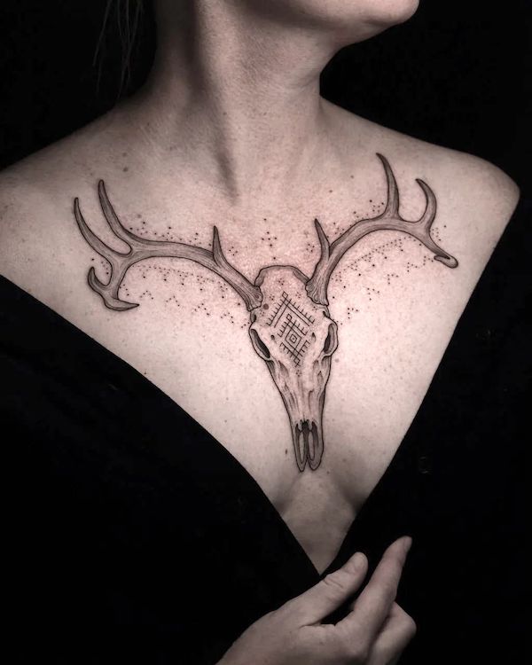 Bold symmetrical deer skull tattoo on the chest by @stockholminktattoo