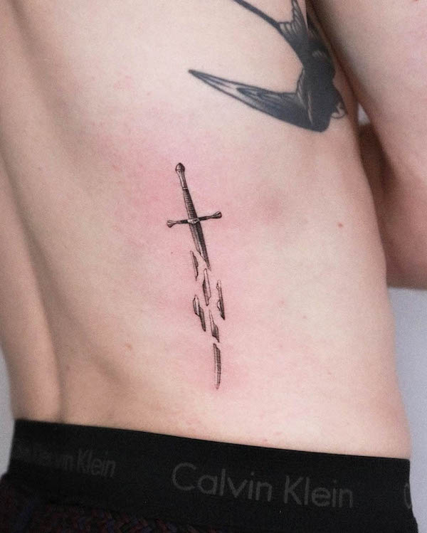 Broken dagger waist tattoo by @oscarjesustattoo