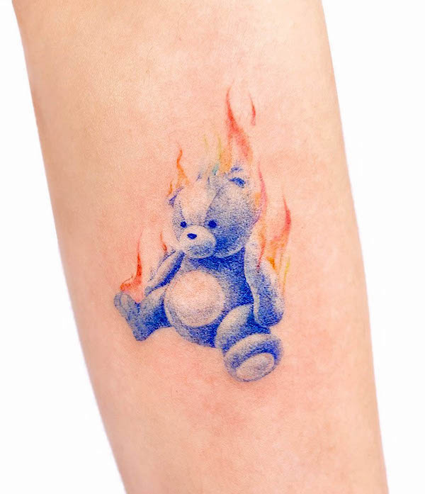 Burning teddy bear tattoo by @uzotattoo