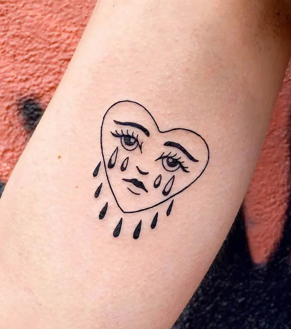 Crying heart bicep tattoo by @doostuff