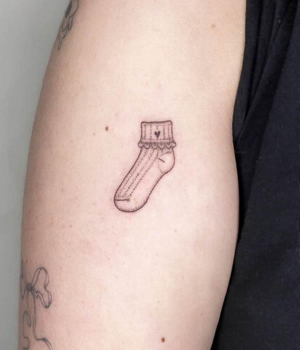 Cute small sock tattoo by @evelyn.tatts