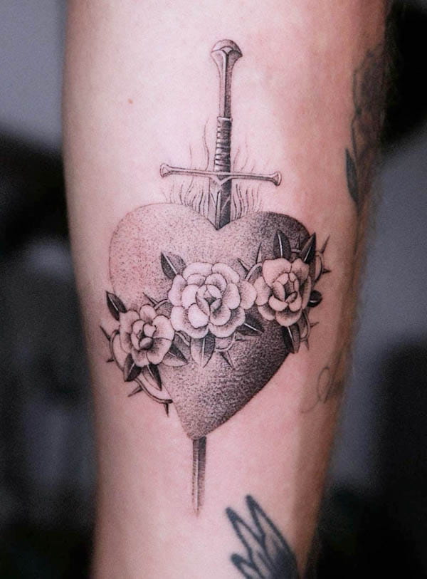 Dagger through a burning heart by @oscarjesustattoo