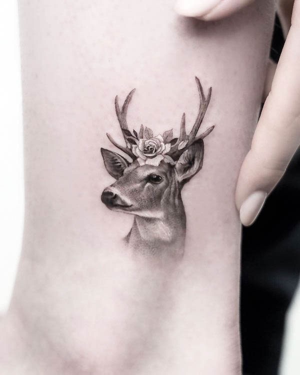 Deer head with flowers tattoo by @sana.ink