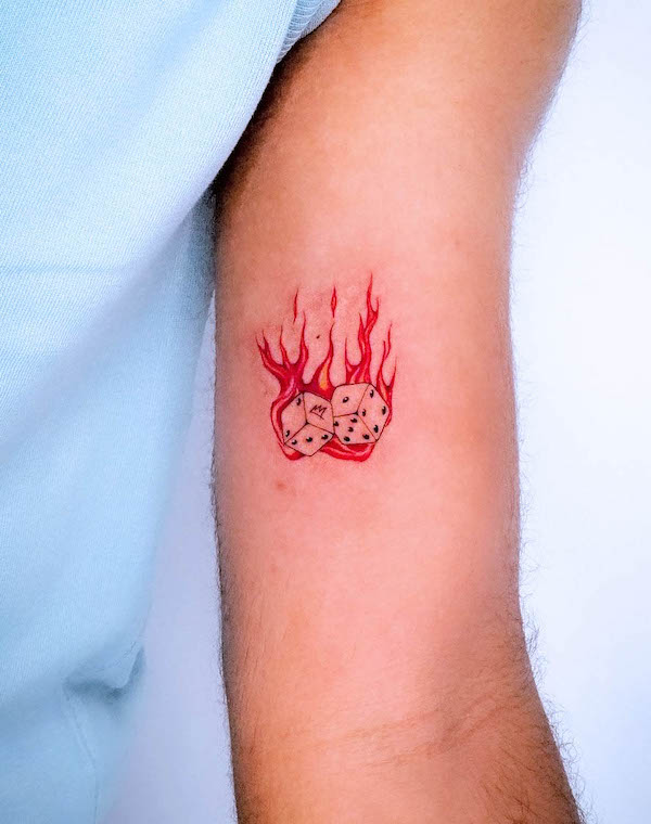 Dice on fire tattoo by @monkeynoma_tattoo