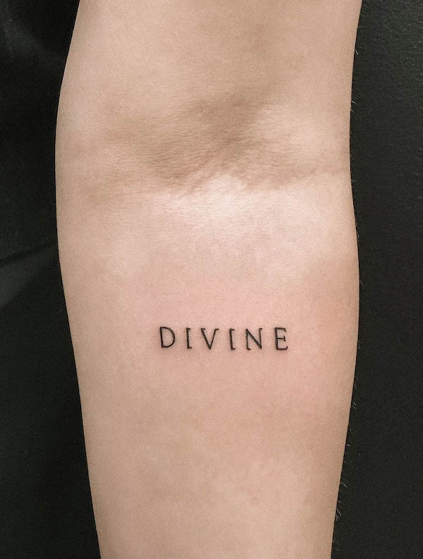 Divine one word tattoo by @hybridink.helsinki