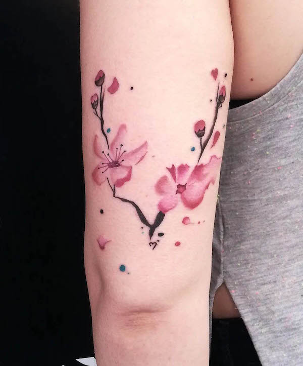 Feminine watercolor cherry blossom tattoo by @freddy_tattoo_studio