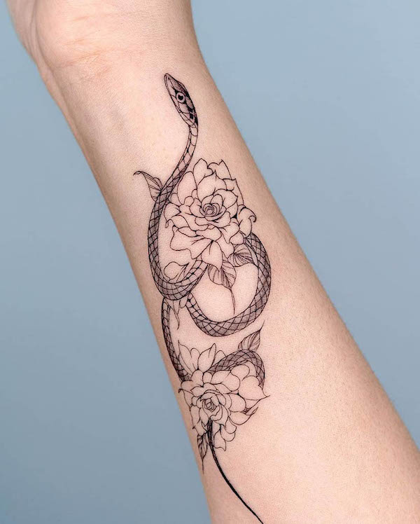 Floral snake forearm tattoo for women by @bium_tattoo