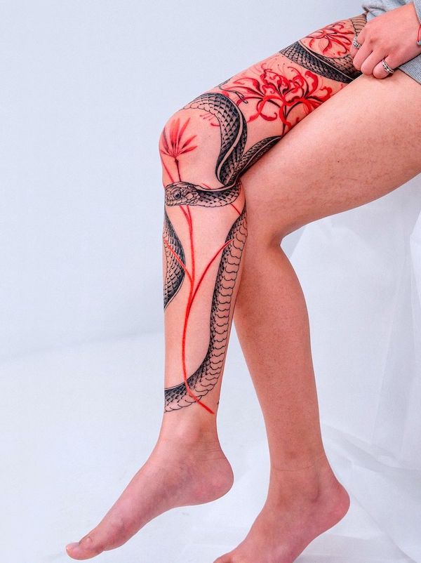 Flowers and snake full leg tattoo for women by @oozy_tattoo