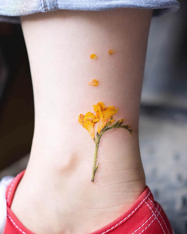 Freesia flower foot tattoo by @pokhy_tattoo