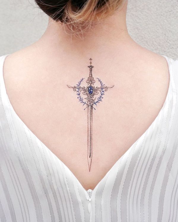 Gemstone sword on the back by @tattooist_solar