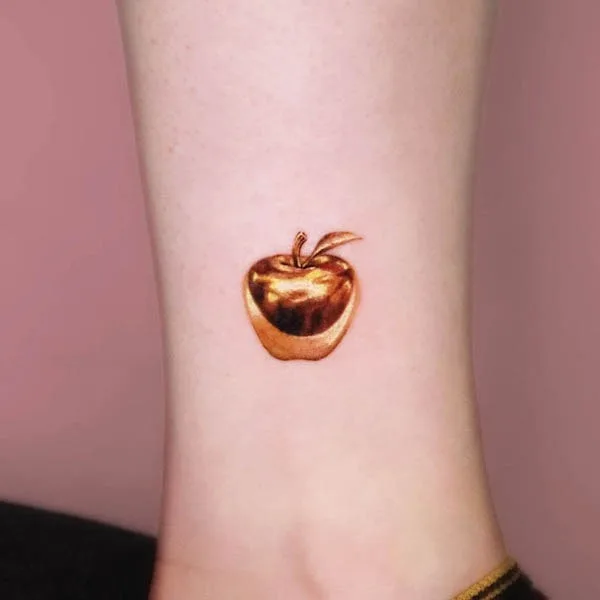 Golden apple tattoo by @studio_jaw