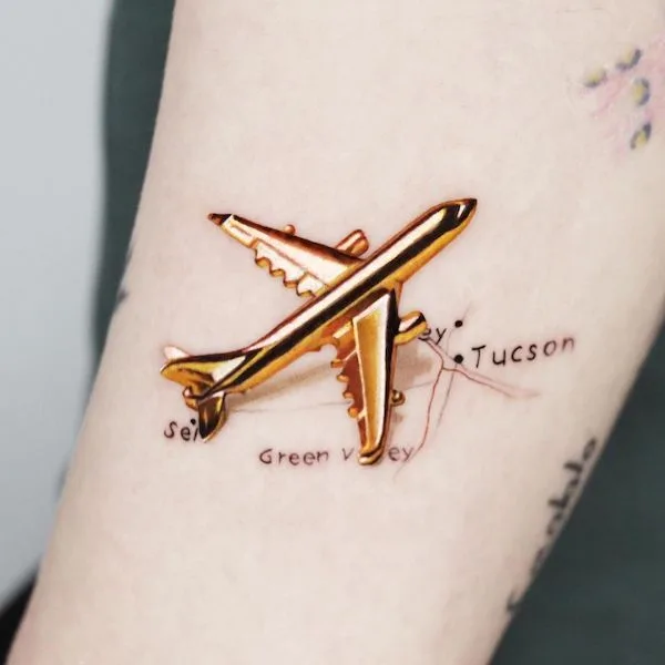 Golden plane tattoo by @jooa_tattoo