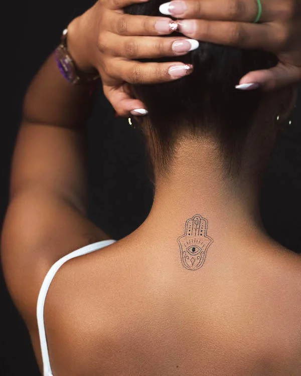 Hamsa tattoo on the back of neck by @alegomeztattoo