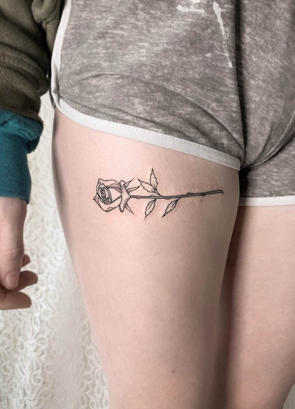 Horizontal rose thigh tattoo by @kirkbudden