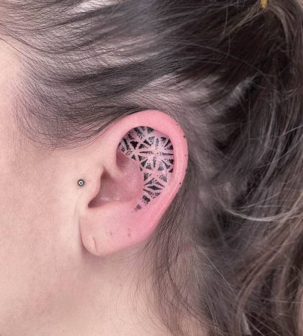 Inner ear blackwork by @remybtattoo