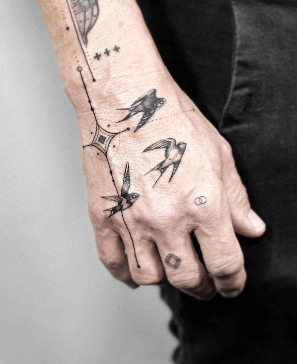 Intricate swallow hand tattoo by @gabrielepalma