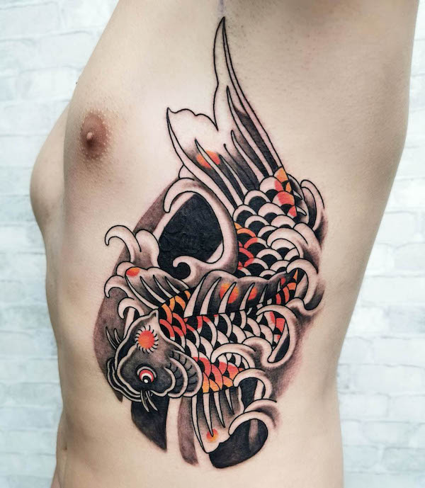 Traditional Japanese koi fish side tattoo for men by @ferrando_nicolas