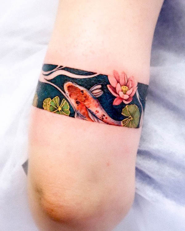 Koi fish in a pond tattoo by @yshiww