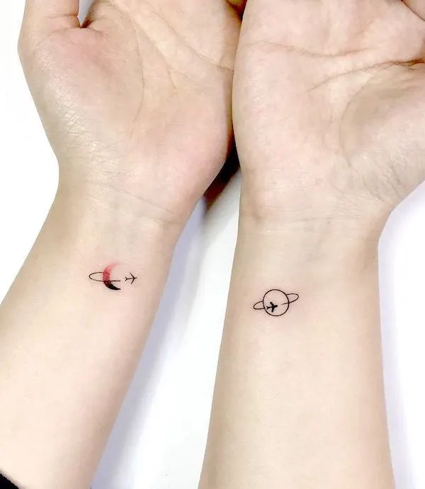 Matching cosmos airplane tattoos by @playground_tat2