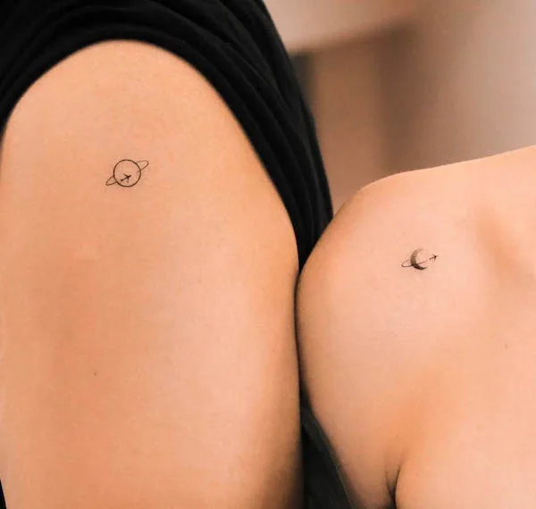 Matching earth and moon shoulder tattoos by @nhi.ink