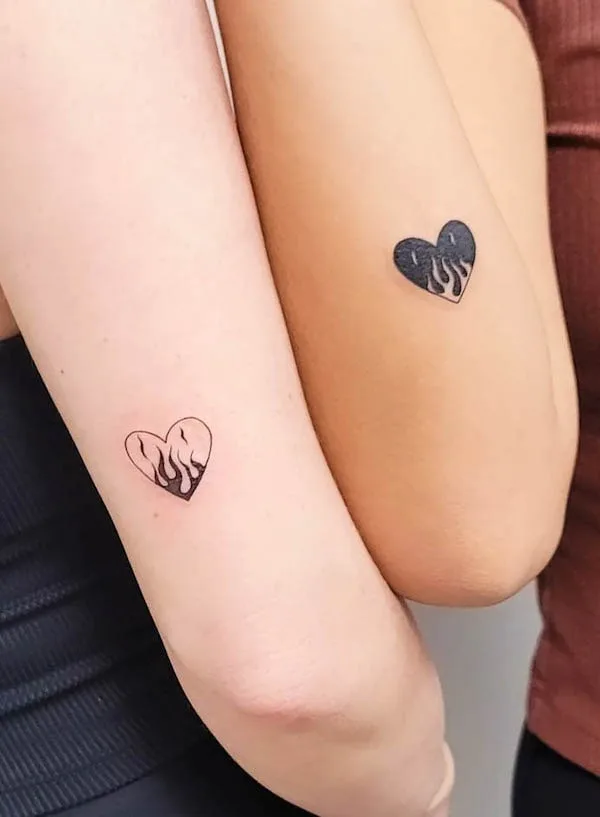 Matching fire heart tattoos by @el.aesthetic.tattooer