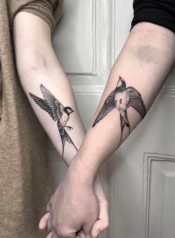 Matching swallow tattoos for couple by @rebecca_rose_tattoo