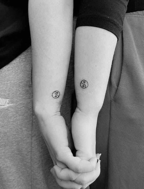 Matching yin yang couple tattoos by @drapal_to_pies_tattoo