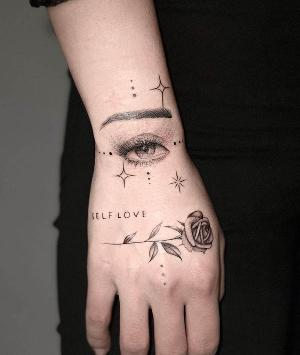 Meaningful eye and rose hand tattoo by @prismatattoo