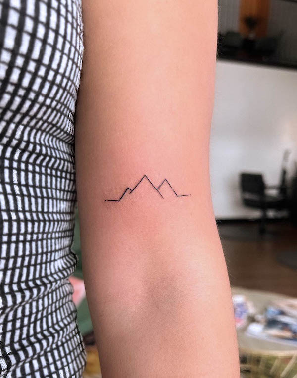 Minimalist mountain arm tattoo by @kwaycreative