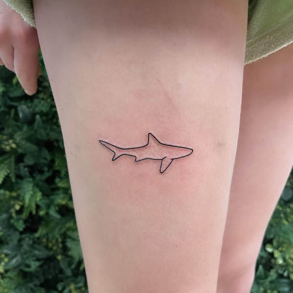 Minimalist shark silhouette tattoo by @chrisharveytattoo