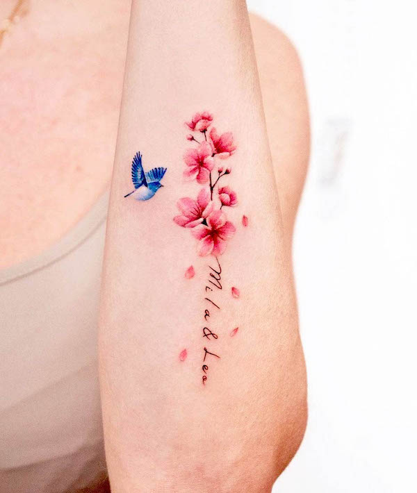 Name and cherry blossom tattoo by @coy.tattoo