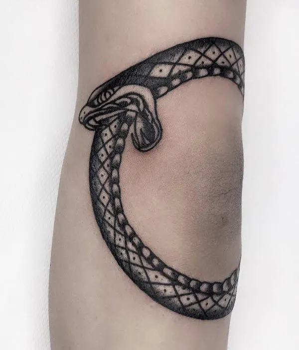 Ouroboros elbow tattoo by @rinor_electrictattooing