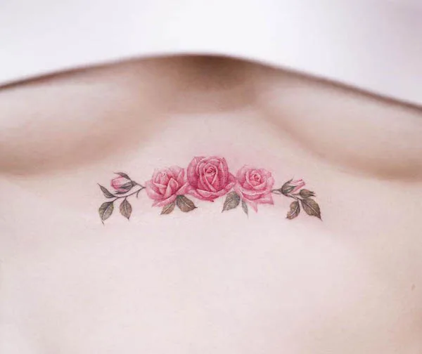 Pink rose under the boobs by @tattoo.haneul