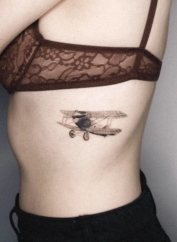 Realism biplane rib tattoo by @miniminionta_ttt