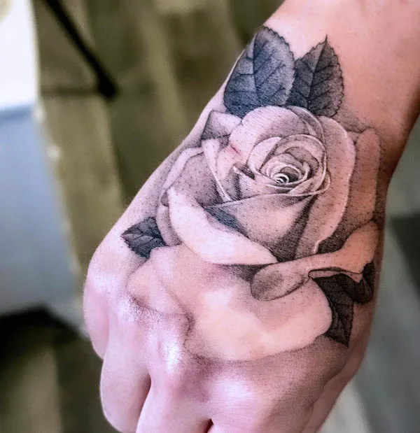 Realism black and grey rose hand tattoo by @kristinevodon