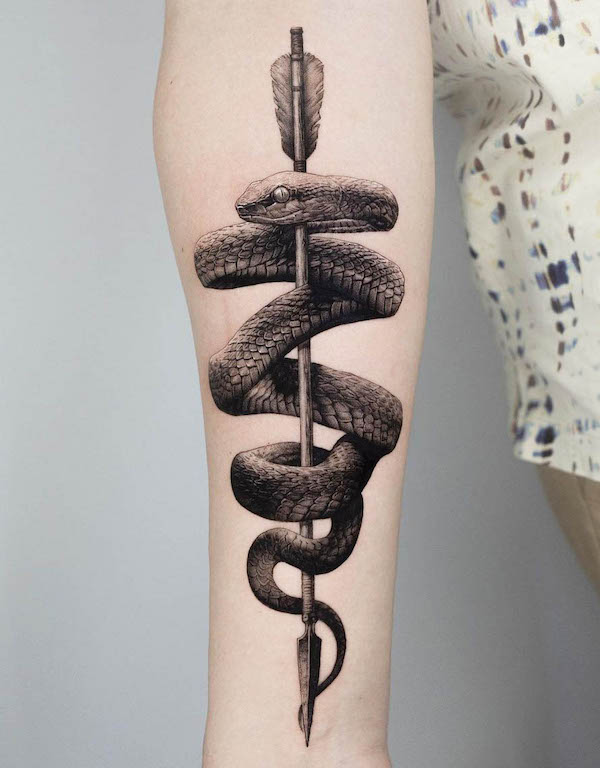 Realism snake and arrow tattoo by @ogitattooer