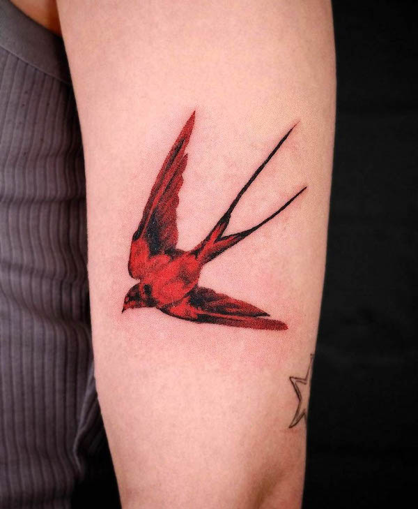 Red swallow arm tattoo by @dvrk_loom_