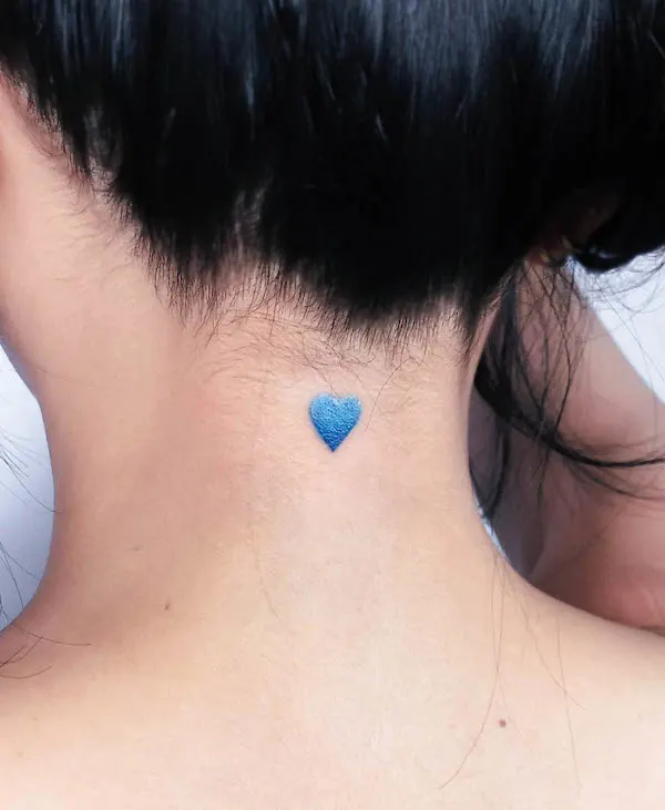 Simple blue heart tattoo behind the neck by @lano.ink_