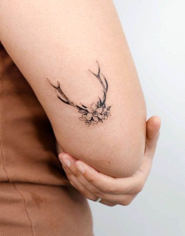 Simple deer antler elbow tattoo by @sera.tattoo