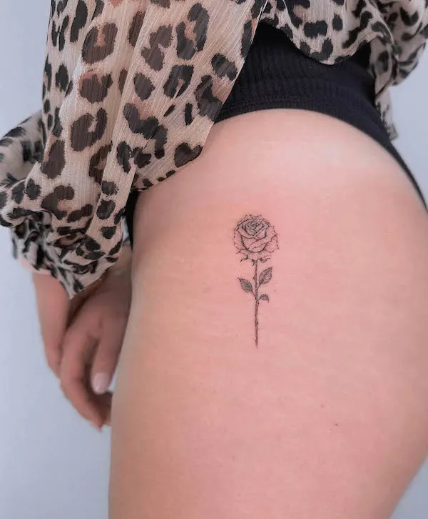 Simple rose outer thigh tattoo by @muroxtattoo